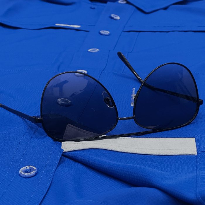 Blue shirt with sunglasses on top