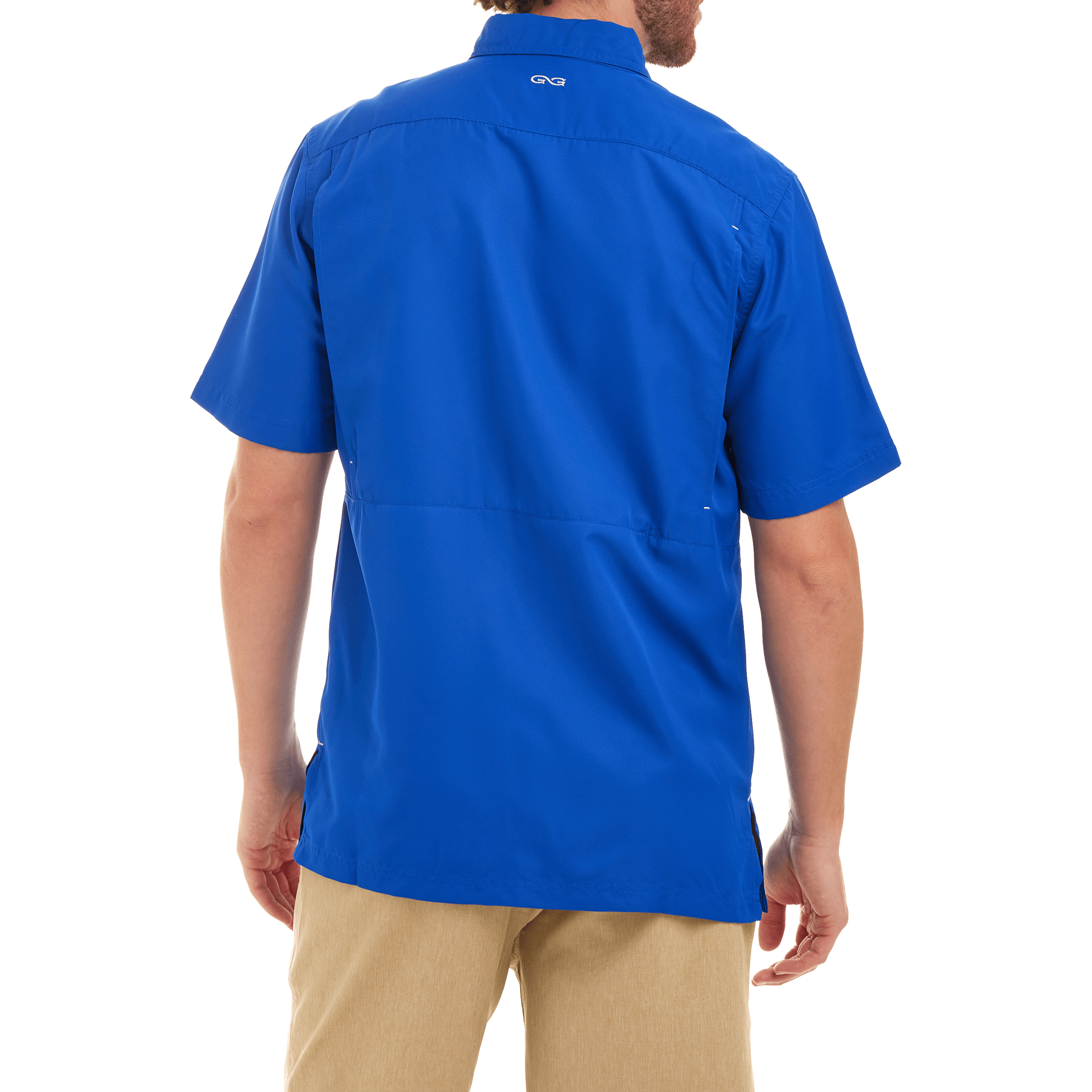 Person wearing a blue shirt with a visible brand logo on the back, standing against a white background.