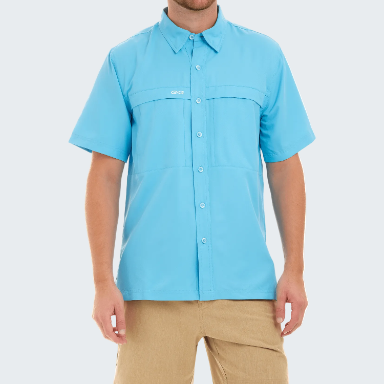 Person wearing a light blue button-up shirt with a brand logo on a white background