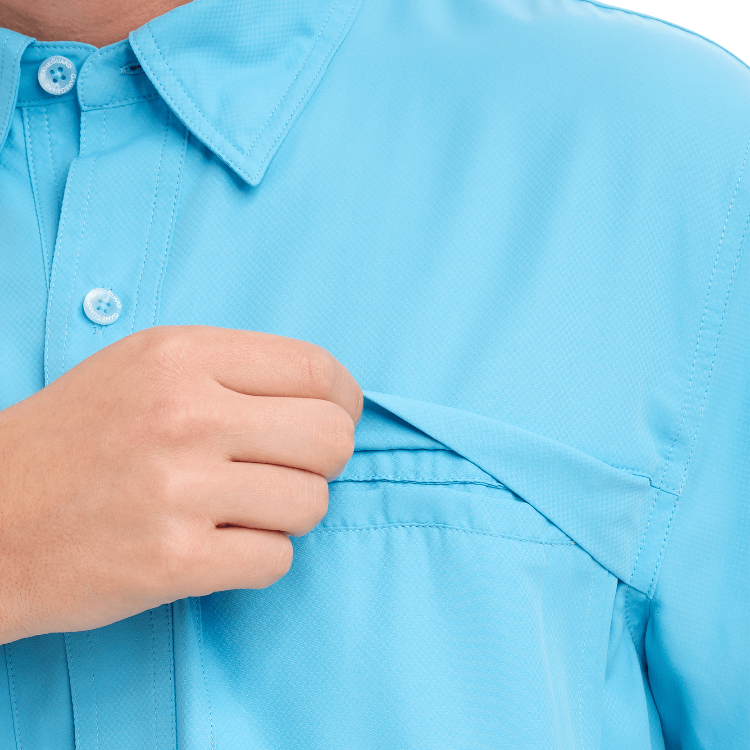 Close-up of a person adjusting the collar of a light blue shirt.