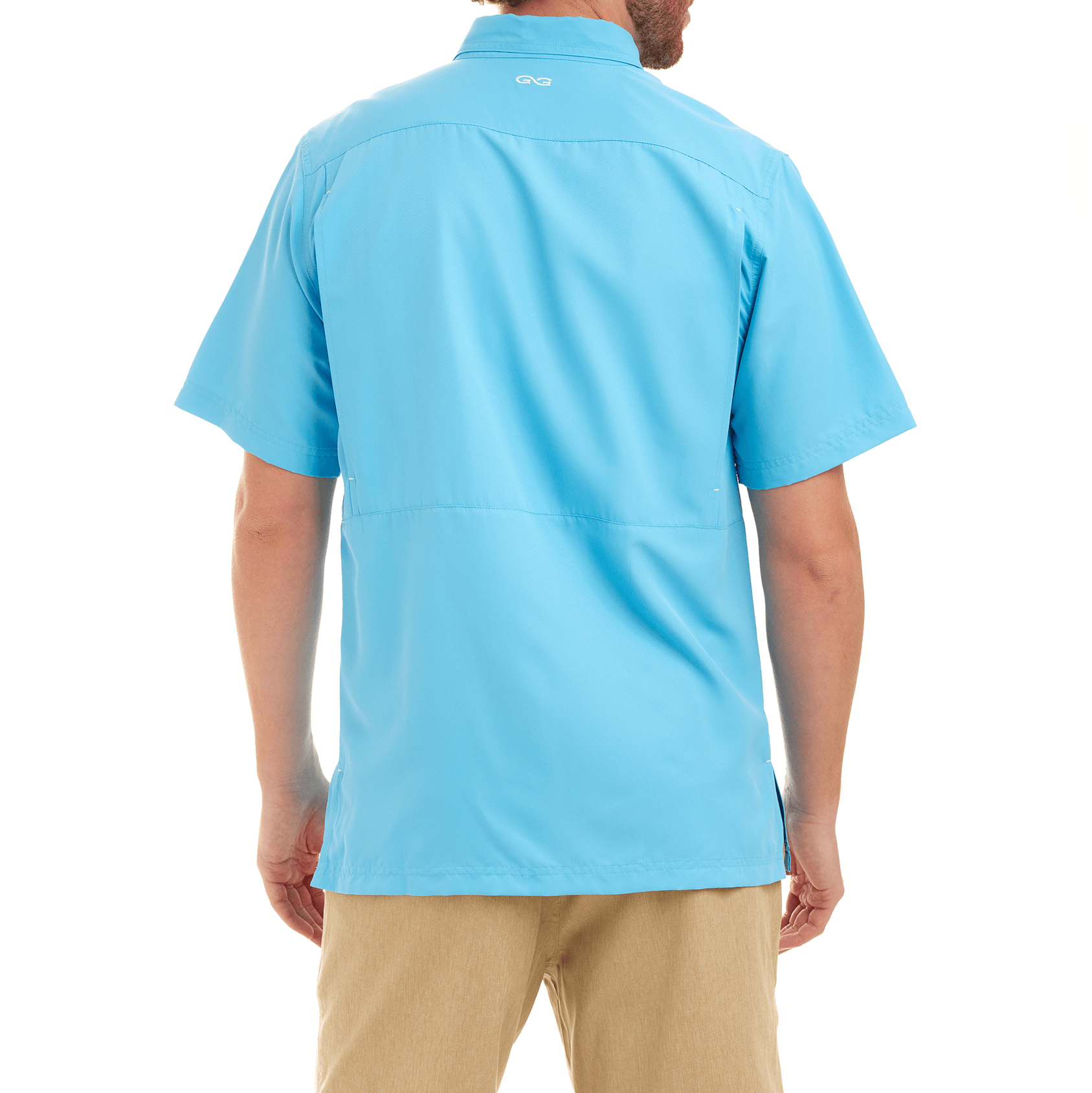 Person wearing a light blue polo shirt with a brand logo on the chest, standing against a white background.