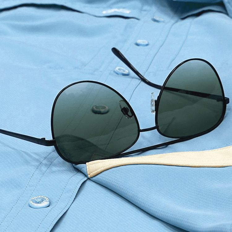 Sunglasses with a wooden frame on a light blue shirt