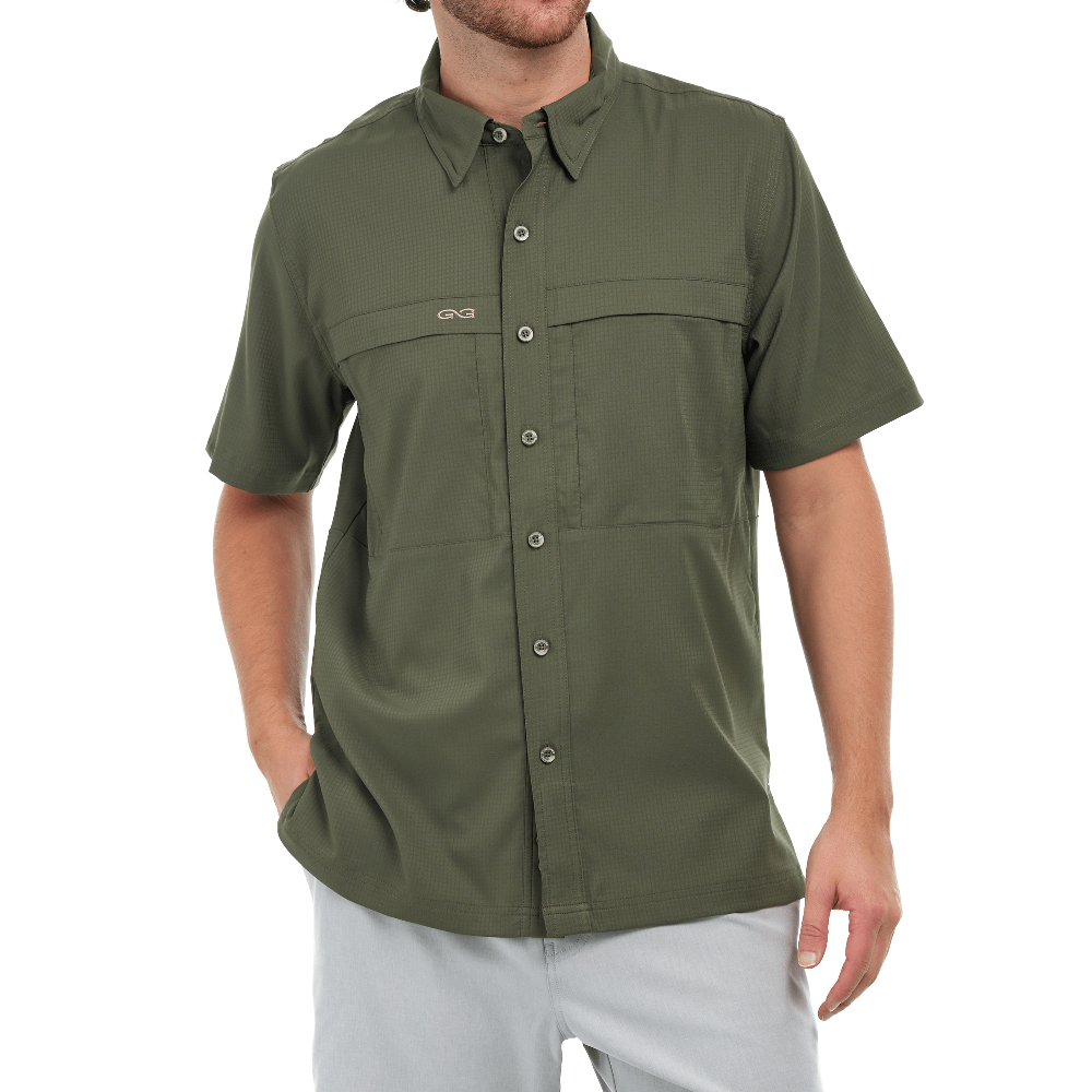 Green short-sleeve shirt worn by a person on a white background