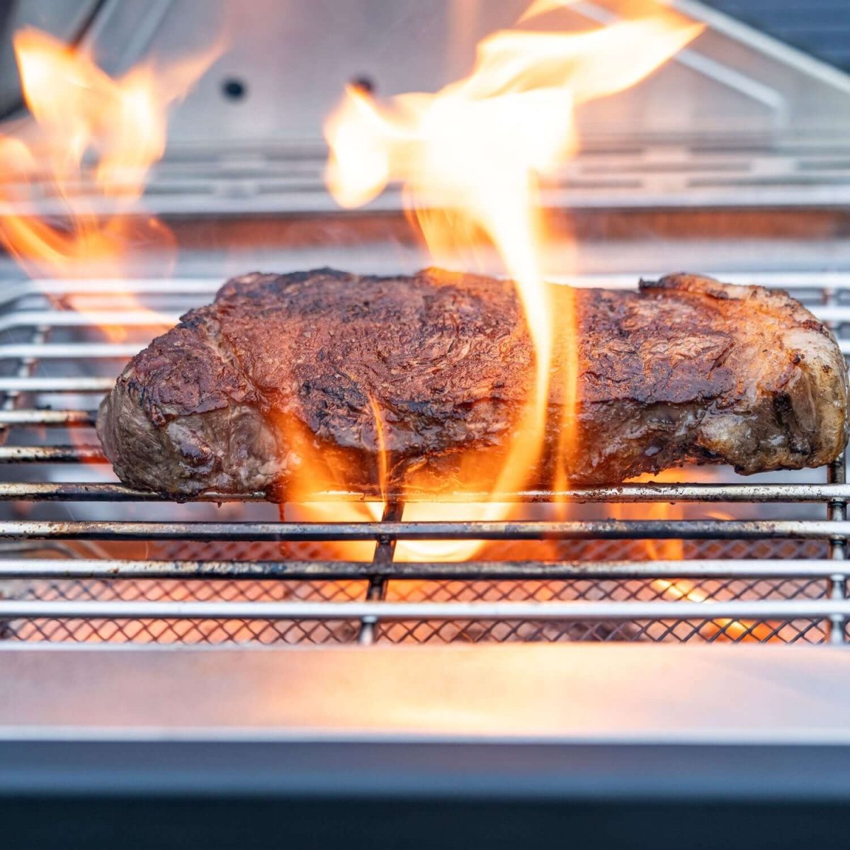 Flaming steak on a grill