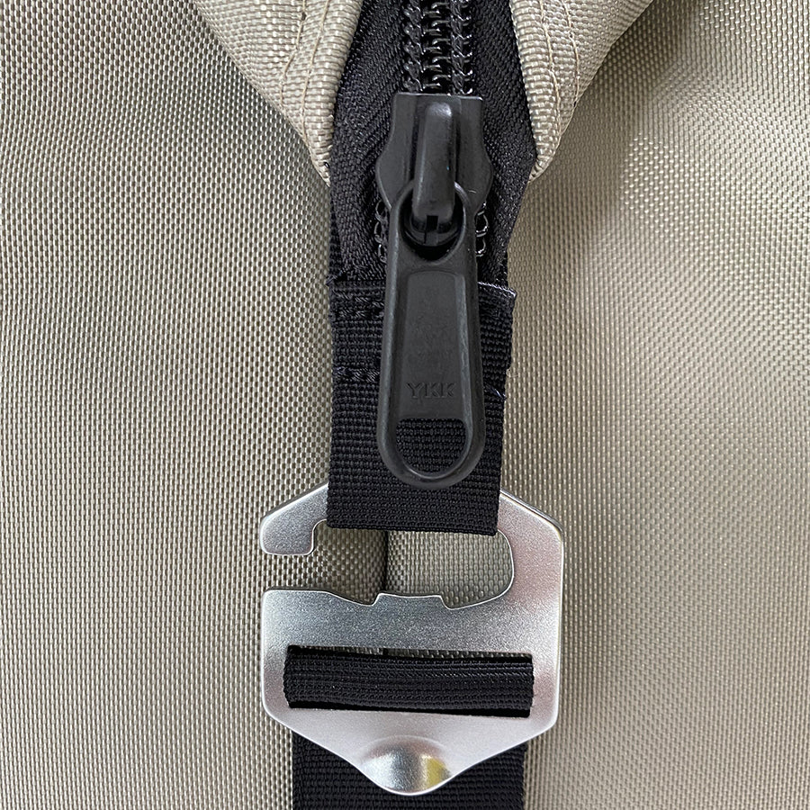 Close-up of a zipper on a beige fabric background