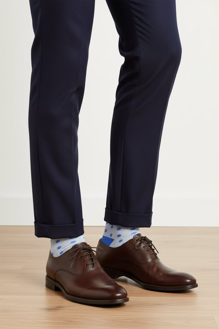 Knee-high sock with blue polka dots on a white background