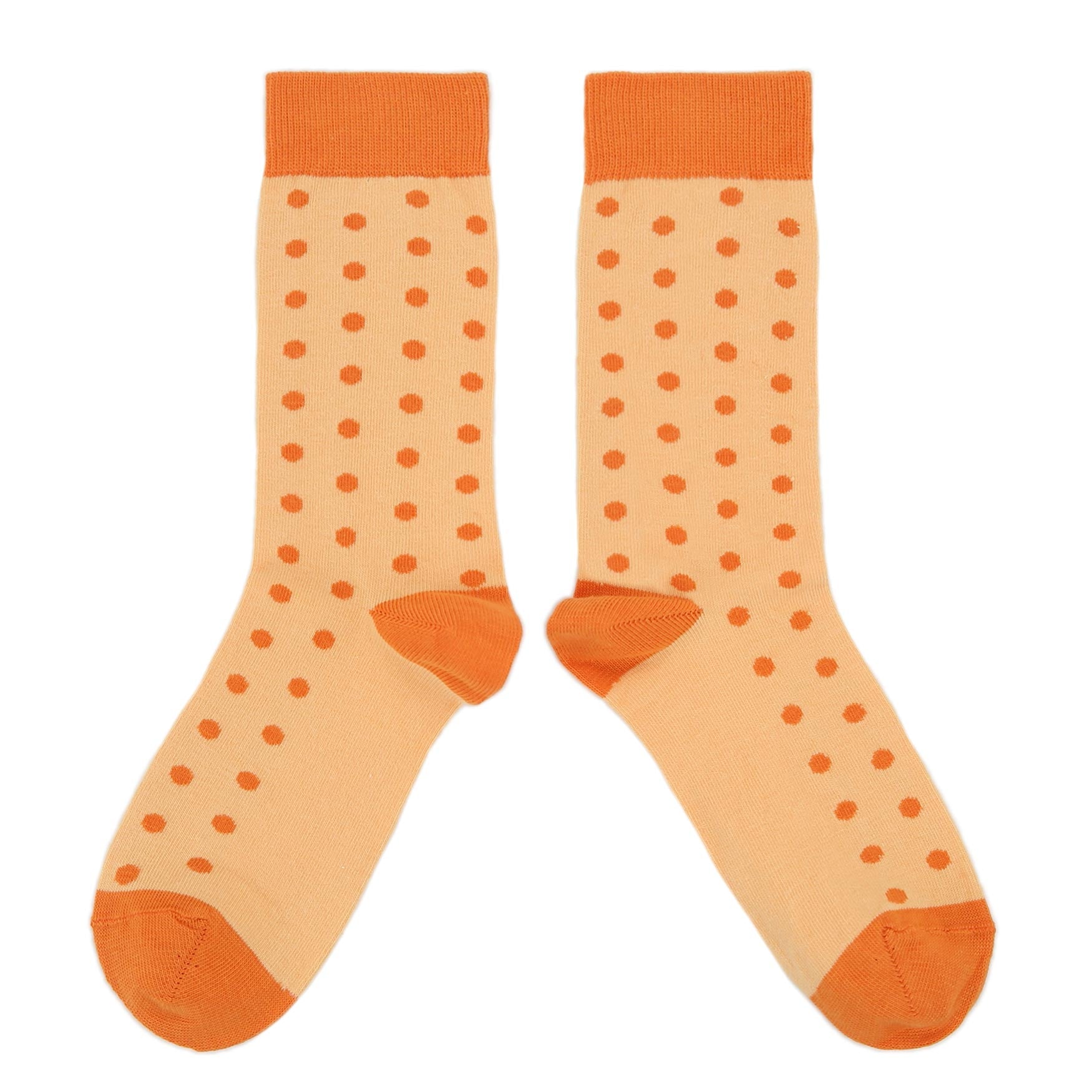 Pair of orange polka dot socks on a white background