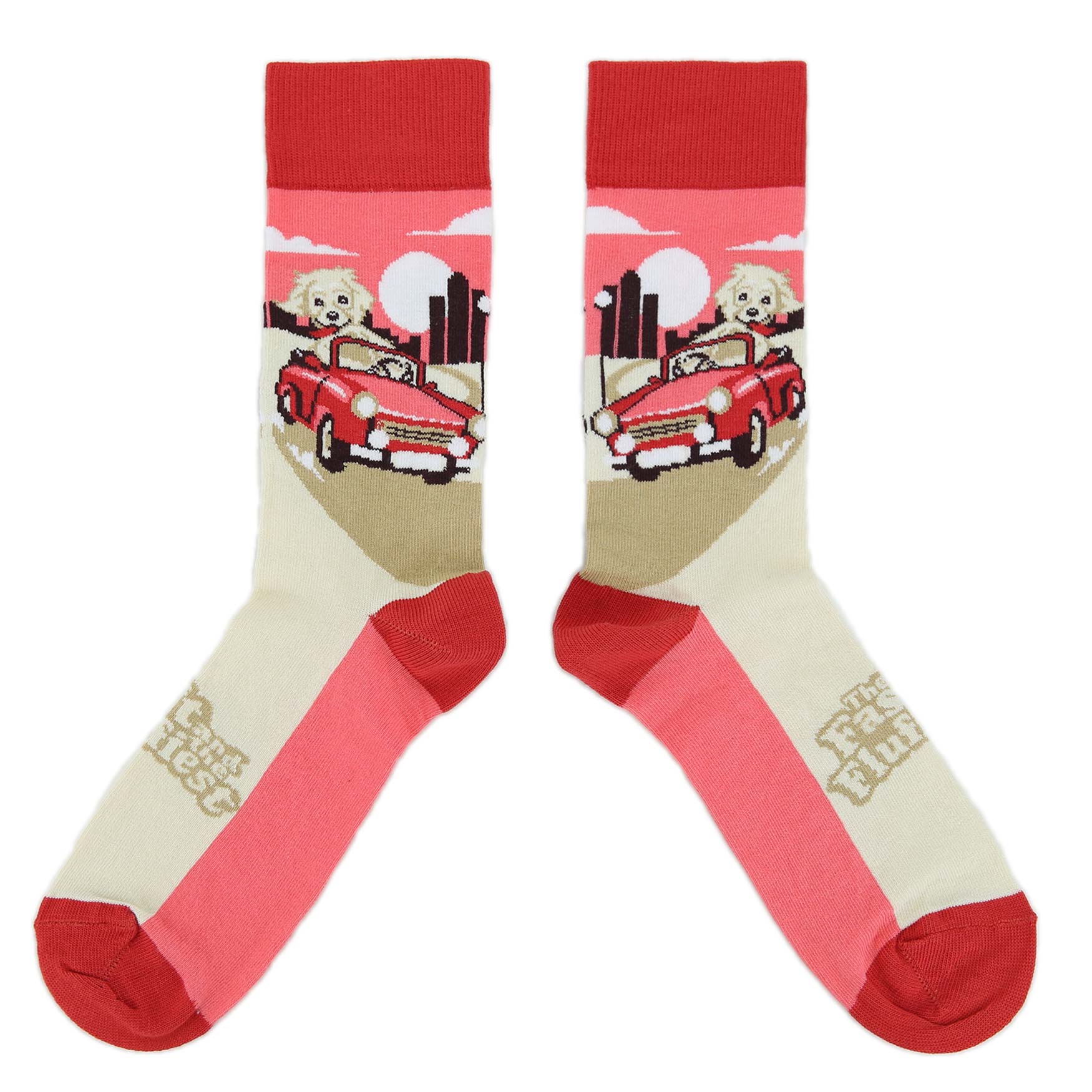Pair of socks with a design of a dog in a red car on a beige background.