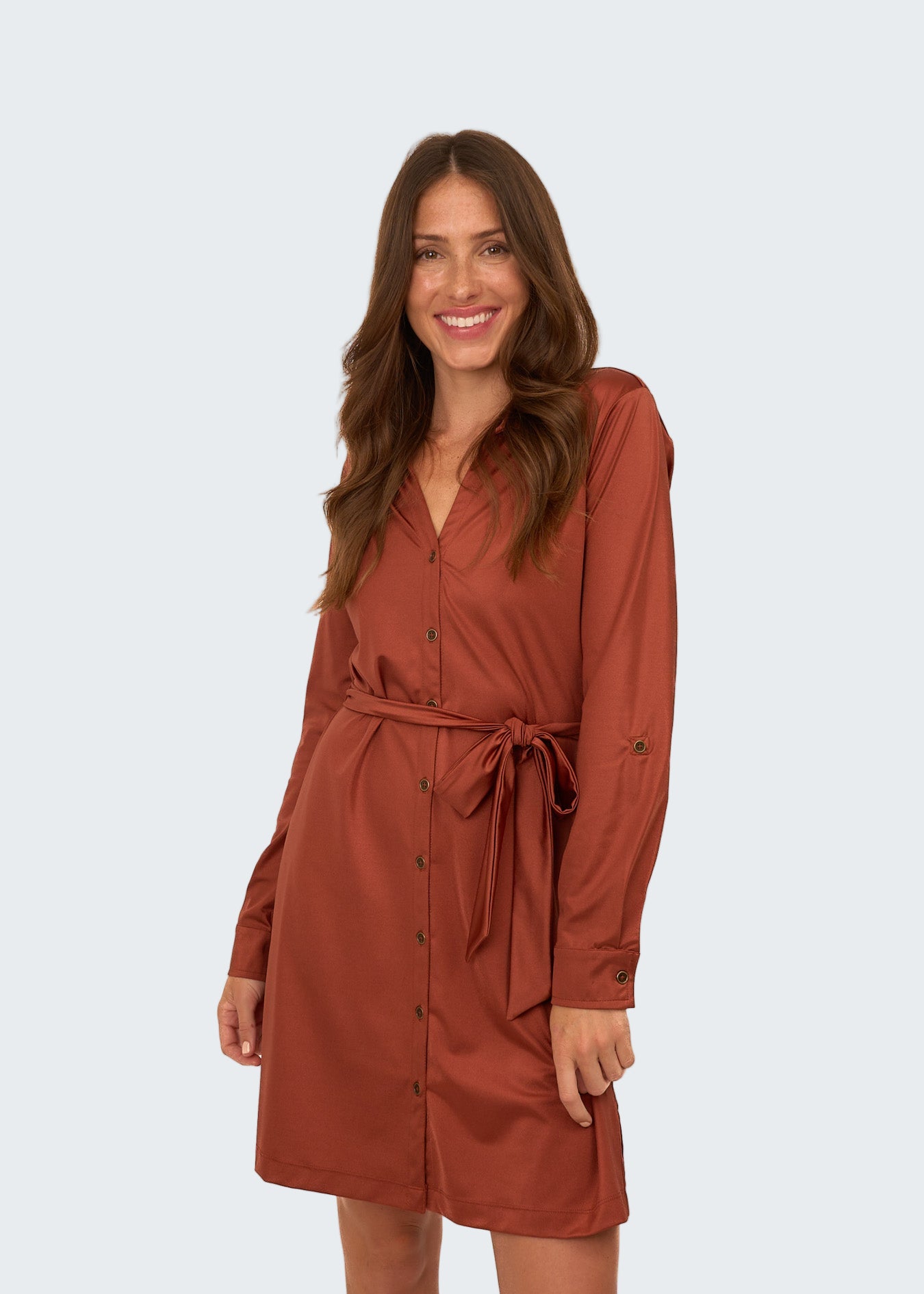 Woman wearing a brown dress with a belt on a white background