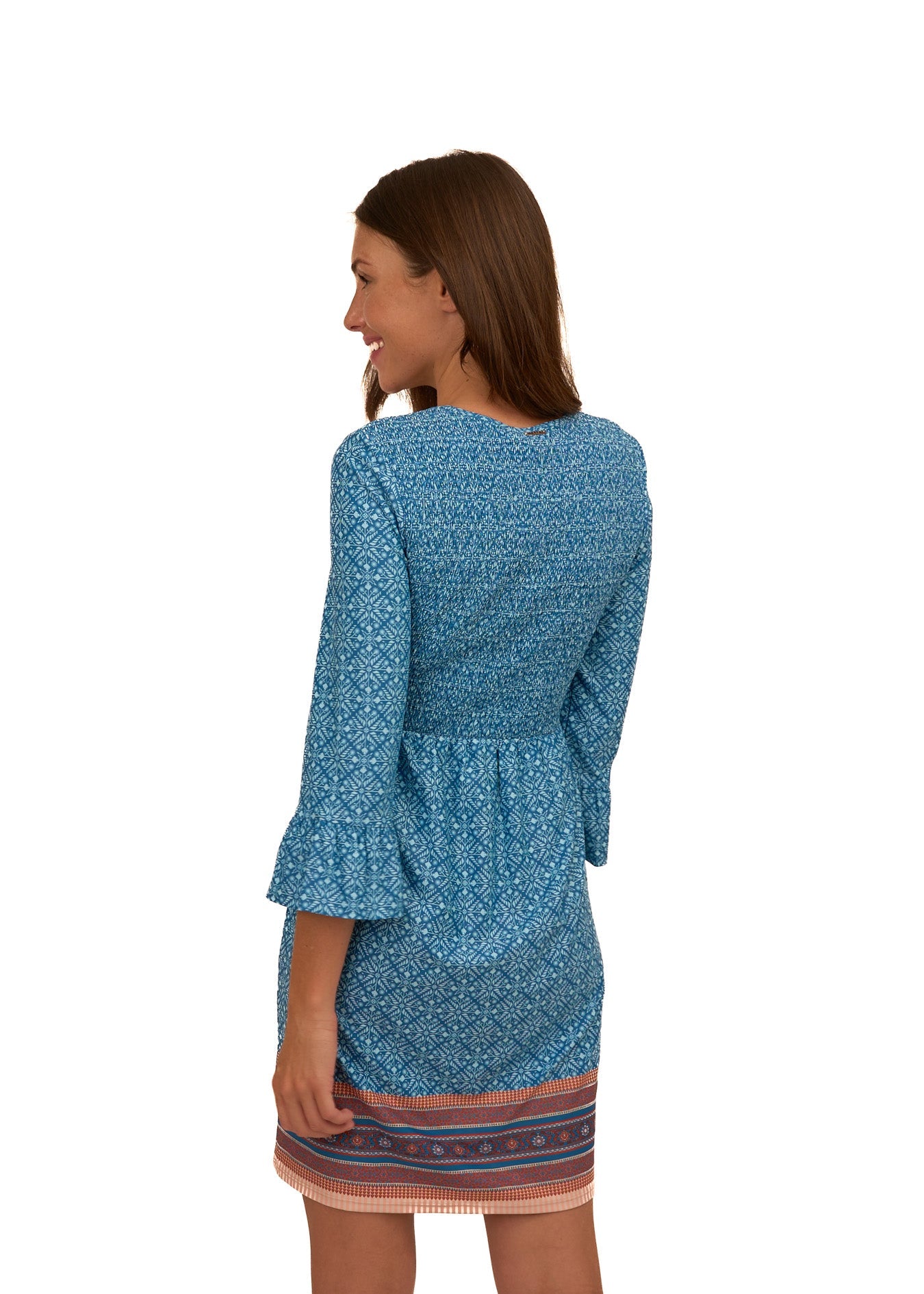 Woman wearing a blue patterned dress with a white background