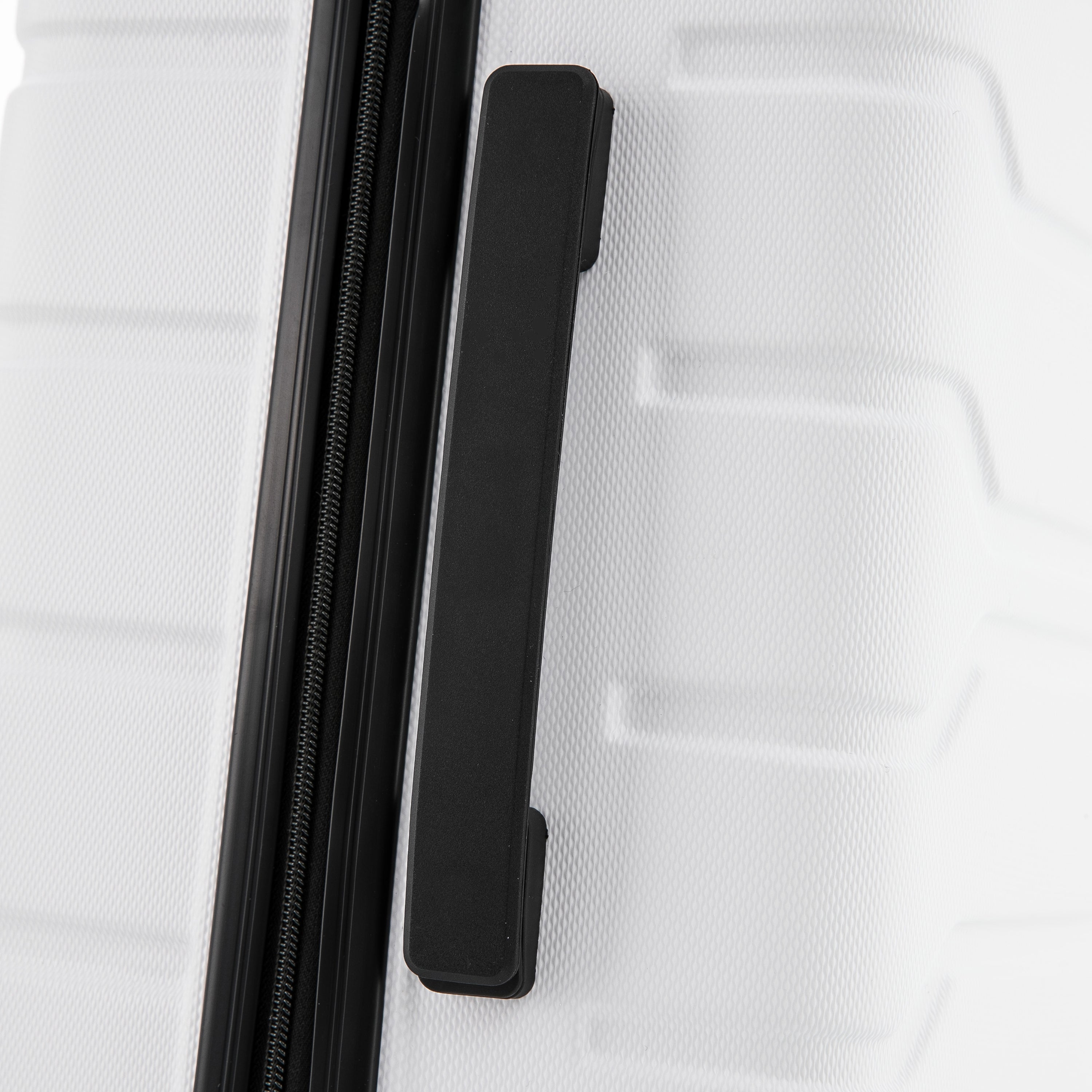 Close-up of a white suitcase with a black handle and zipper on a white background