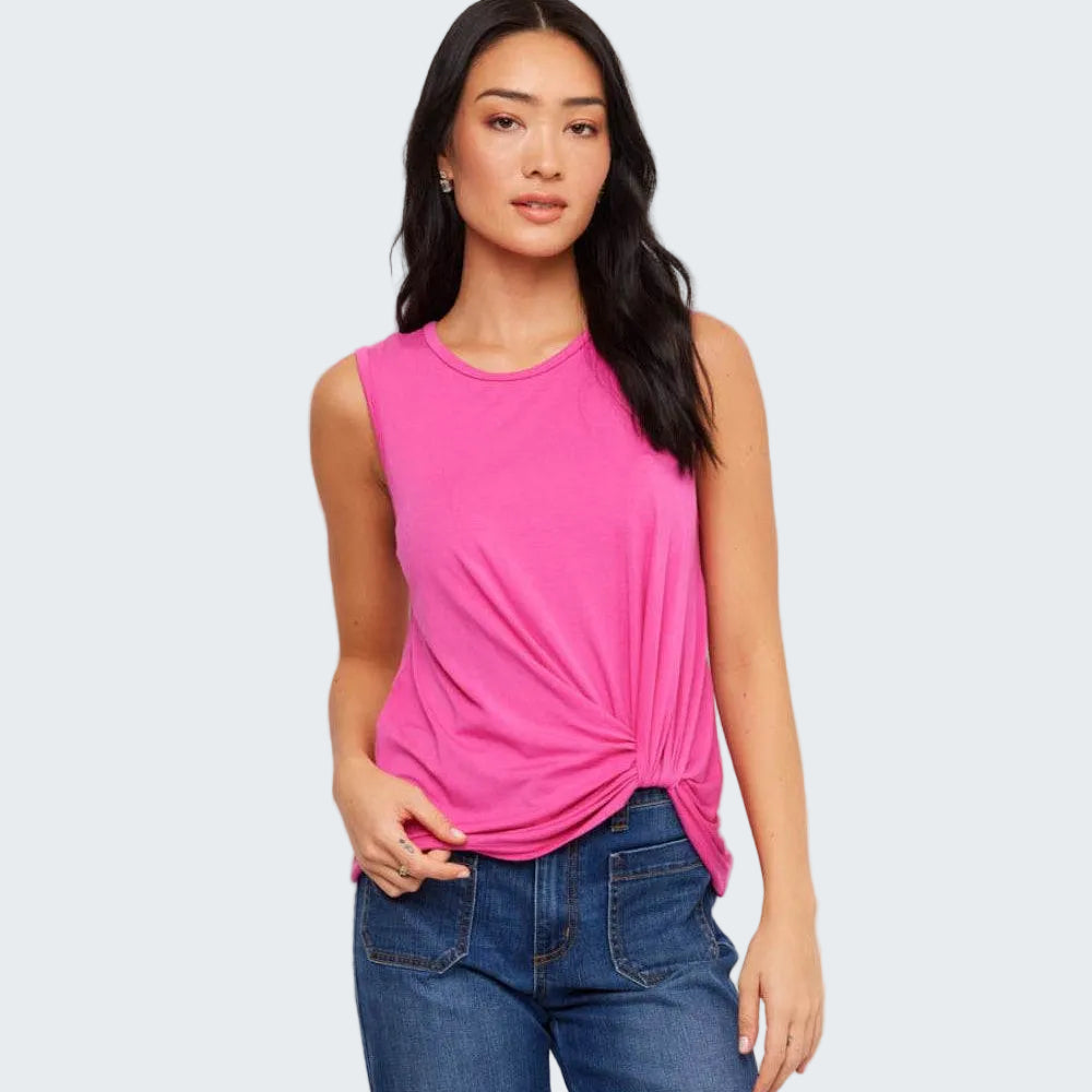 Woman wearing a pink sleeveless top and blue jeans on a white background
