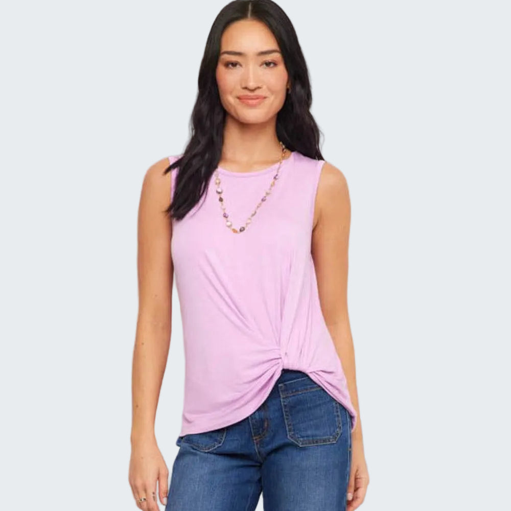 Woman wearing a pink sleeveless top and blue jeans on a white background