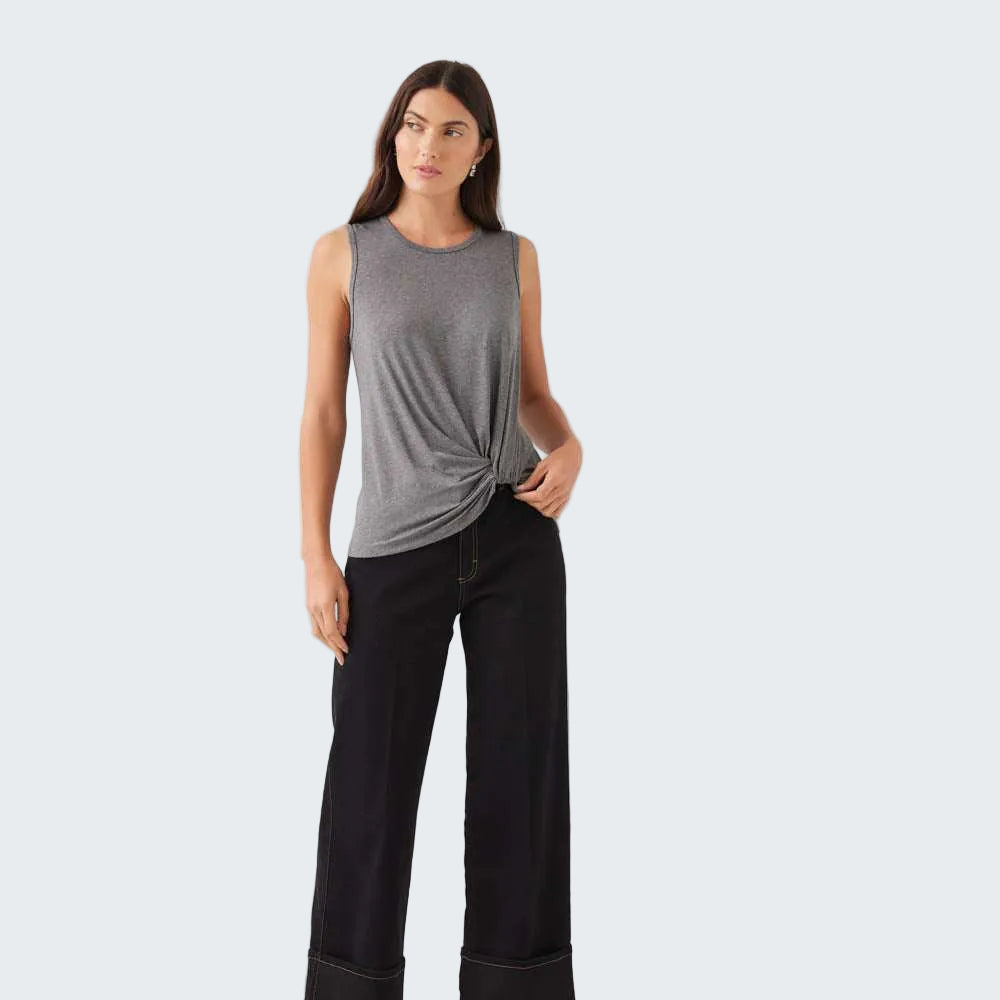 A woman modeling a sleeveless heather gray knit top with a twisted knot detail at the waist, paired with black wide-leg cropped pants and black ankle boots, against a plain white studio background.