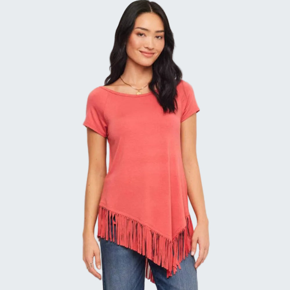 Woman wearing a coral t-shirt with fringe details on a white background