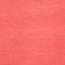 A close-up of a solid coral pink textured material, likely fabric or paper.