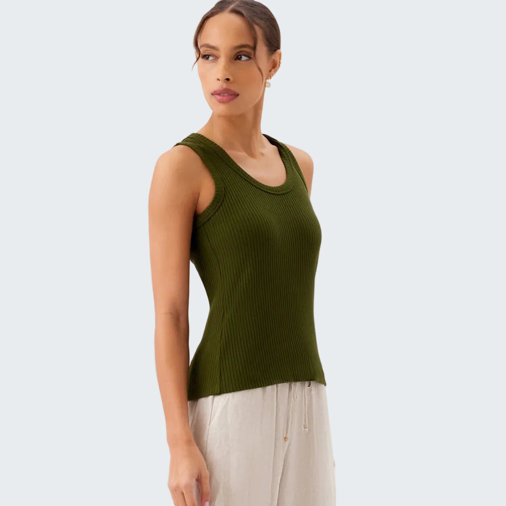 Woman wearing a green sleeveless top against a white background