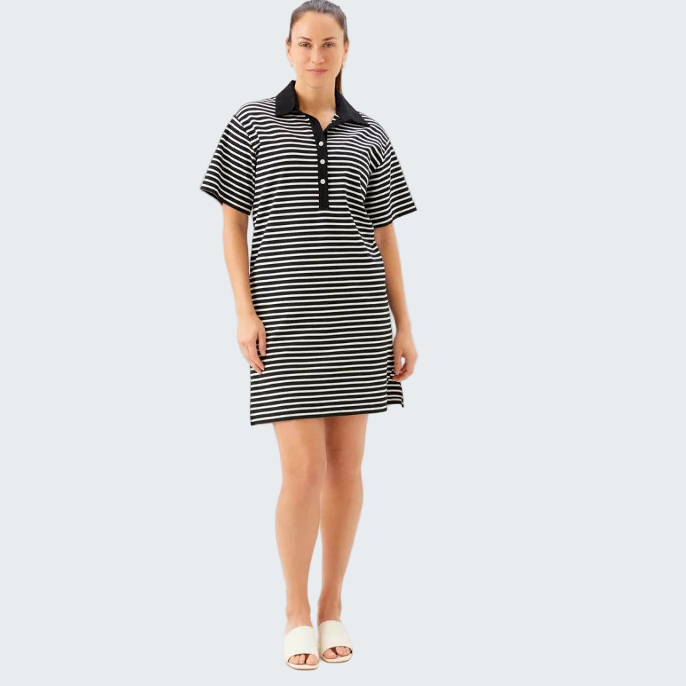 Woman wearing a black and white striped dress on a white background
