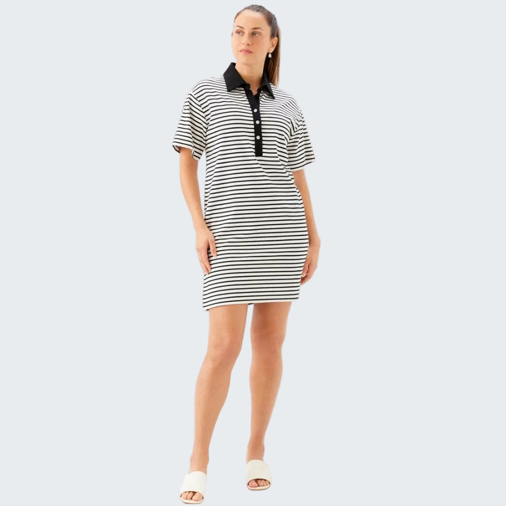 Woman wearing a black and white striped dress with a black collar on a white background