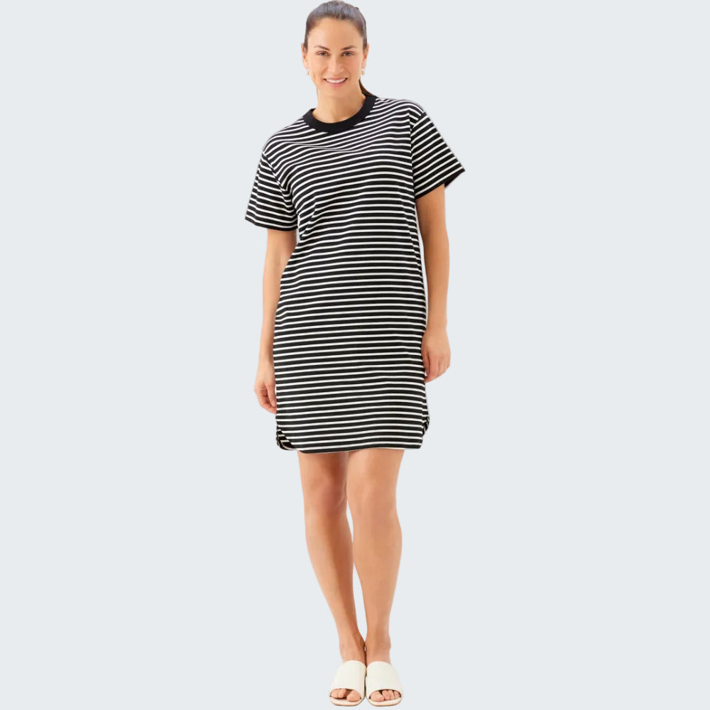 Woman wearing a black and white striped dress on a white background
