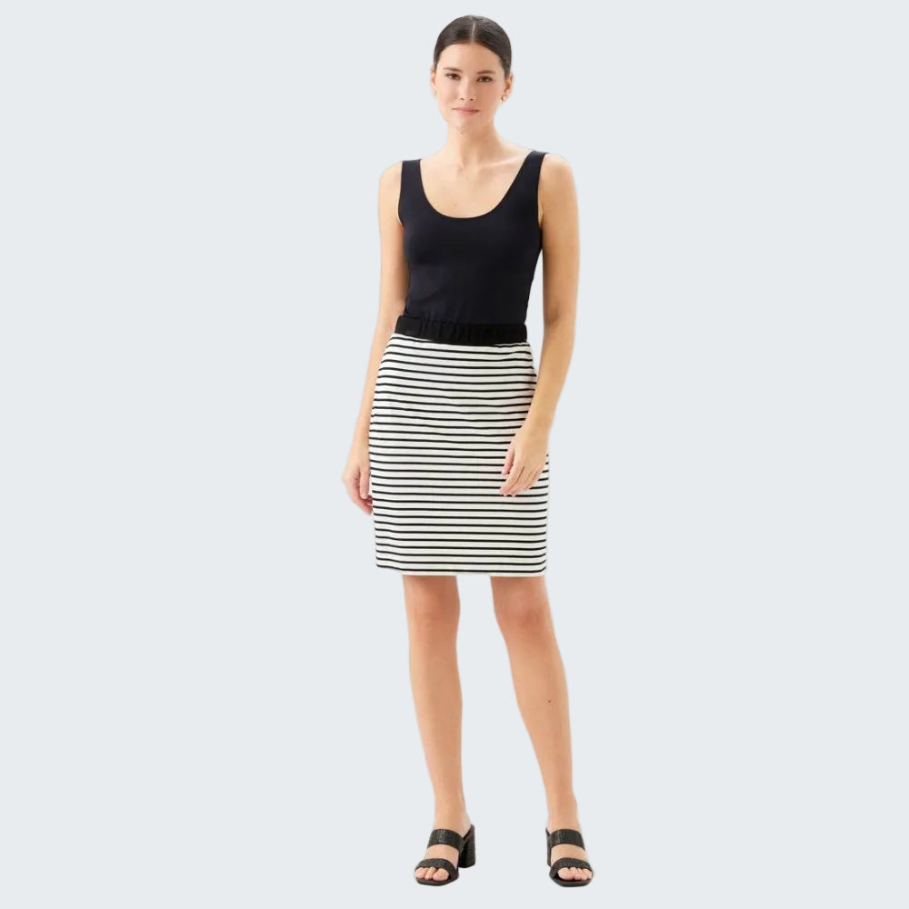 Woman wearing a black tank top and striped skirt on a white background