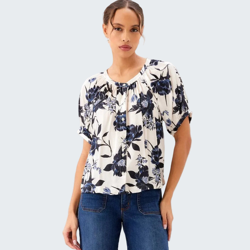 Woman wearing a floral blouse and jeans on a white background