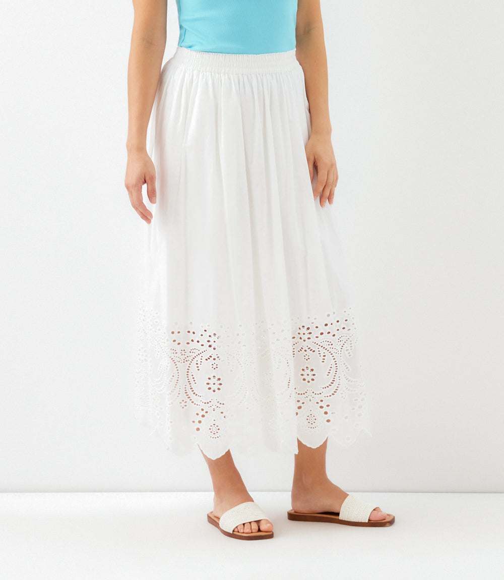 White pants with lace detailing worn by a person on a white background