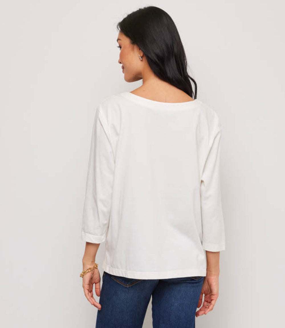 Woman wearing a white blouse with a plain background