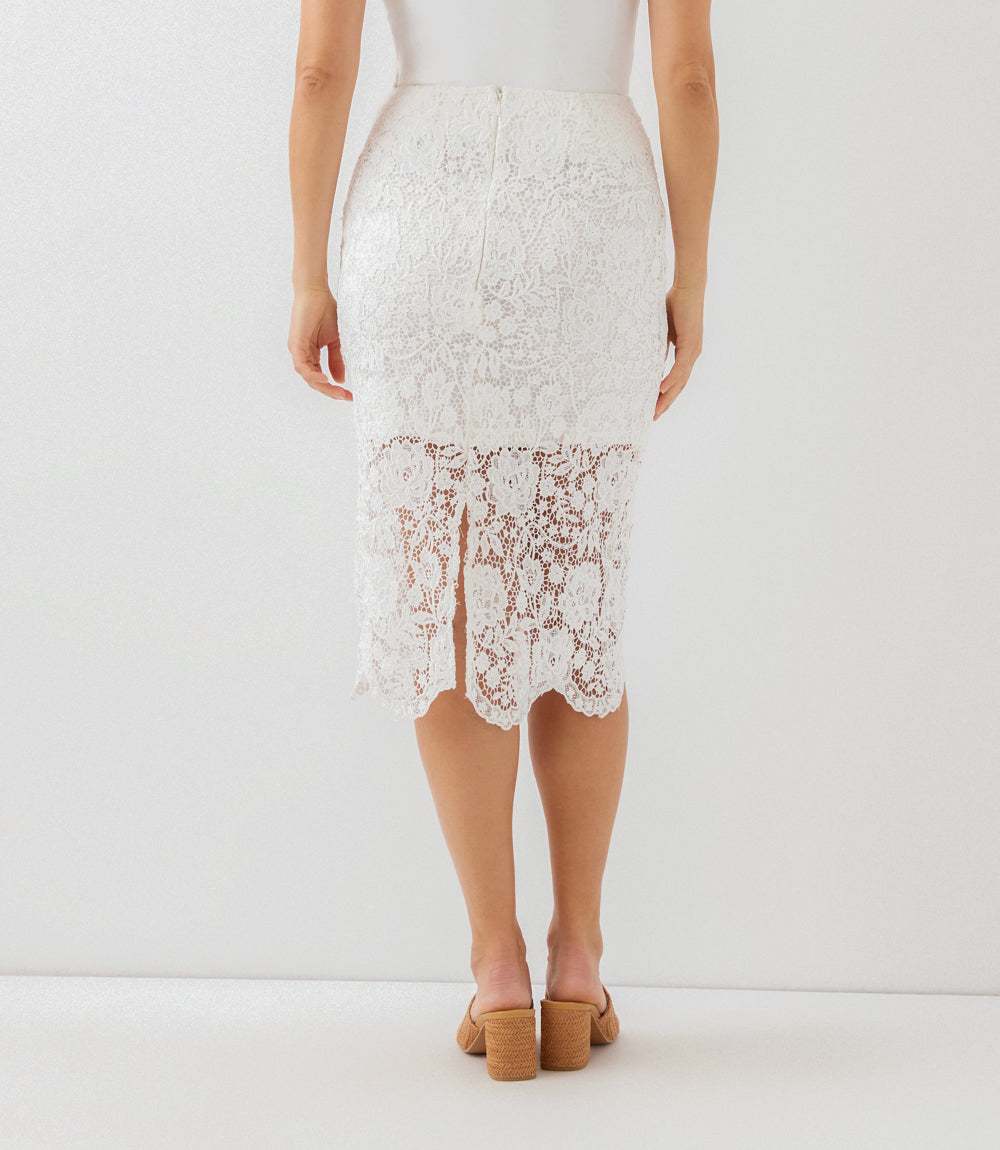 White lace skirt worn by a person on a white background