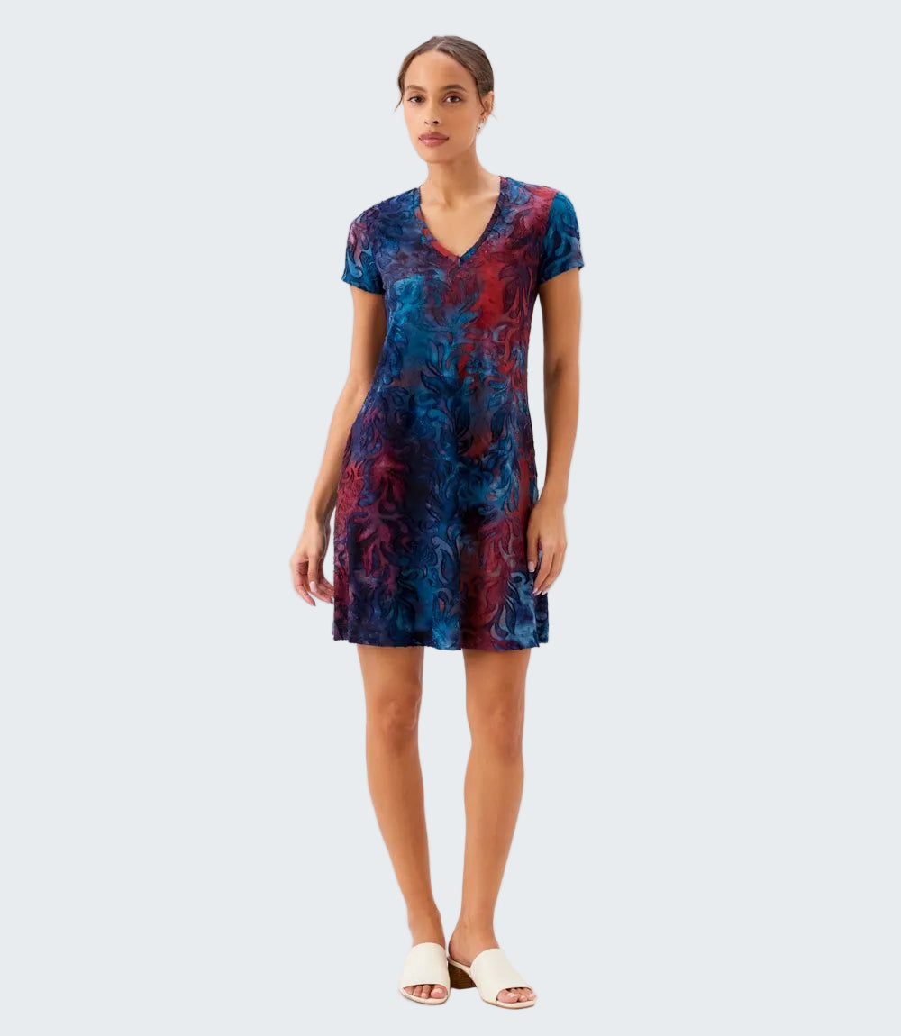 Woman wearing a blue and red patterned dress on a white background