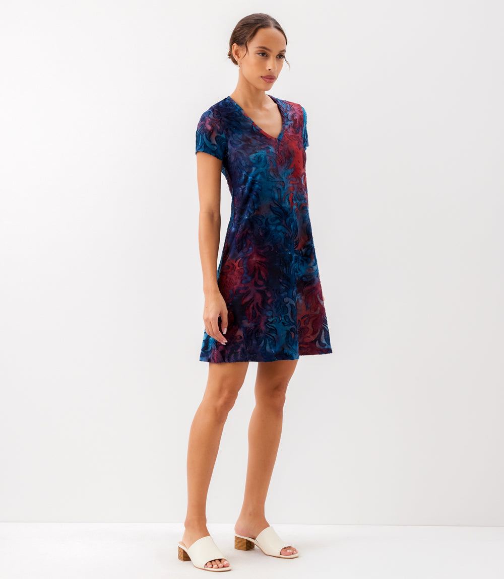 Woman wearing a tie-dye dress on a white background