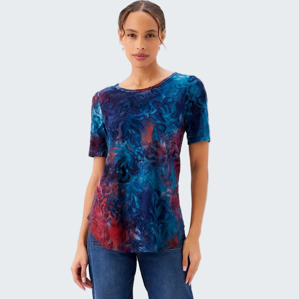Woman wearing a blue and red patterned top on a white background