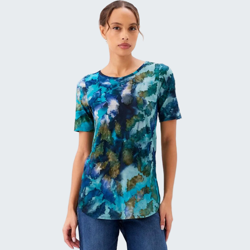 Woman wearing a blue and green patterned shirt against a white background