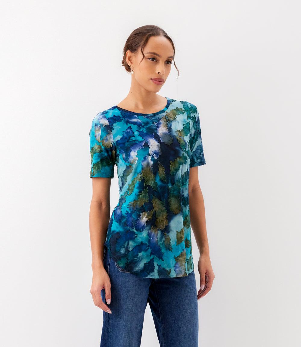 Woman wearing a blue abstract patterned shirt on a white background