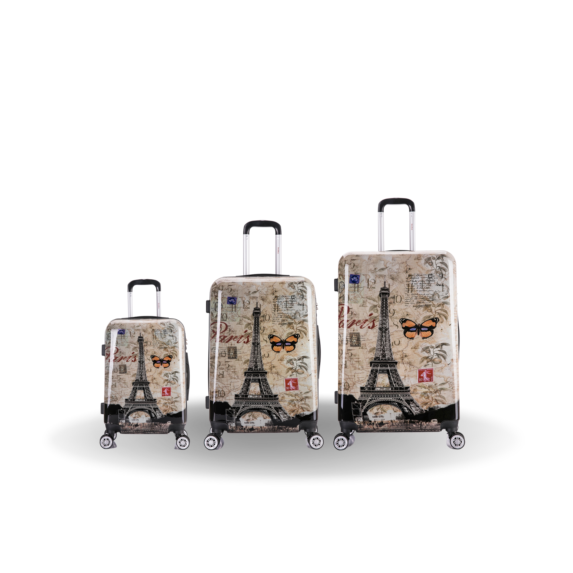 Three suitcases with Eiffel Tower and butterfly design on a white background