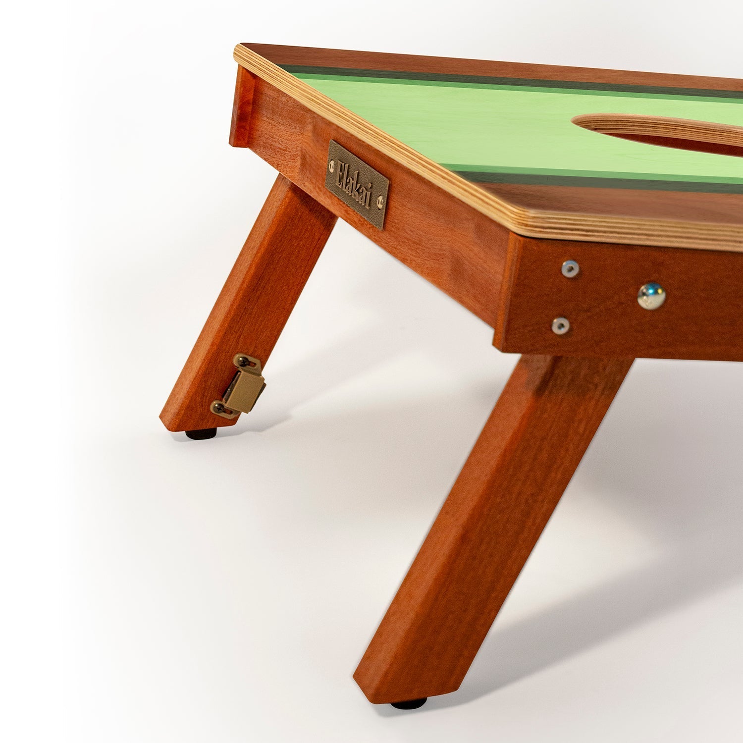 Wooden children's table with green top on a white background