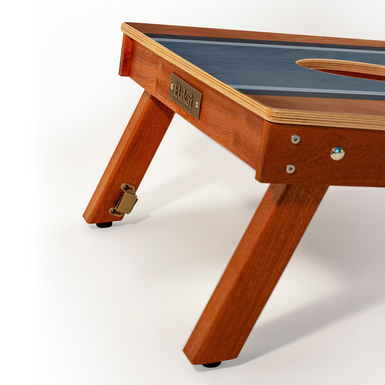 Wooden gaming table with a blue playing surface on a white background