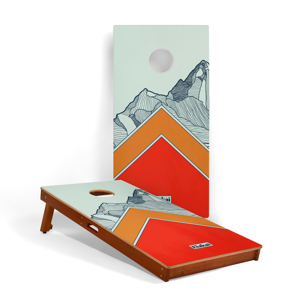 Cornhole board with mountain design on a white background