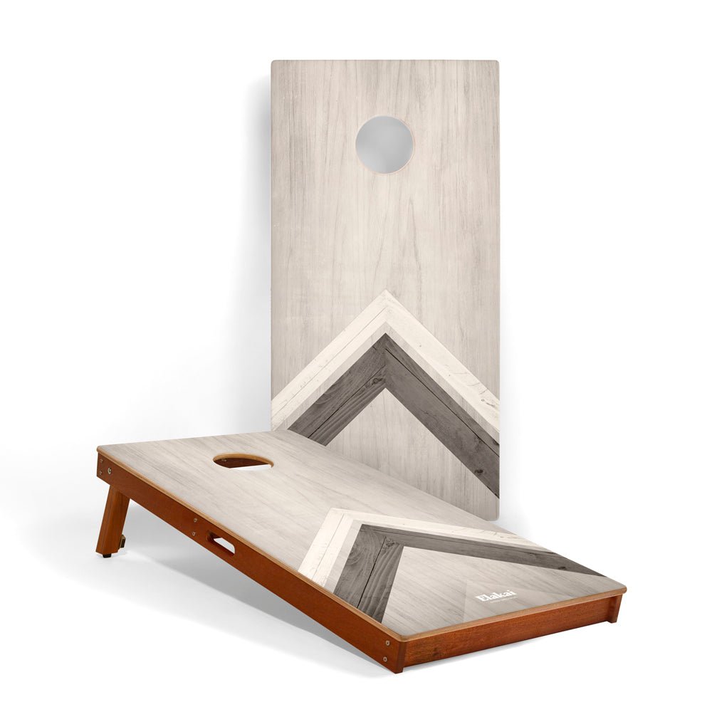 Wooden cornhole board with a geometric design on a white background