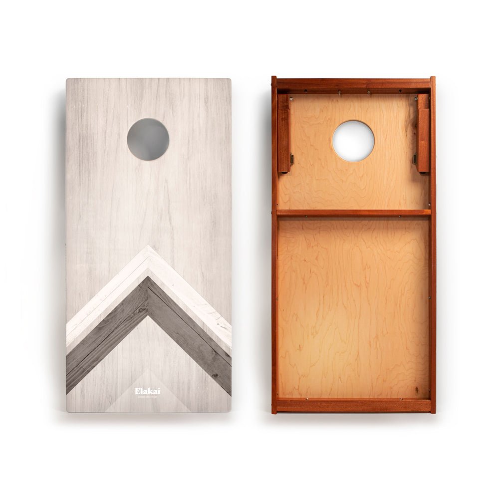 Two wooden cornhole boards with geometric designs on a white background