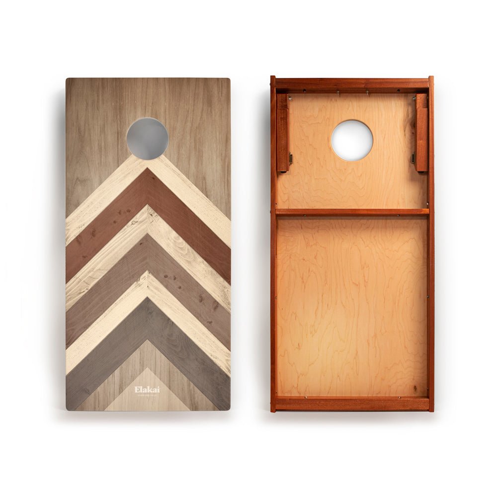 Wooden cornhole board with chevron pattern on one side and plain wood on the other, on a white background.