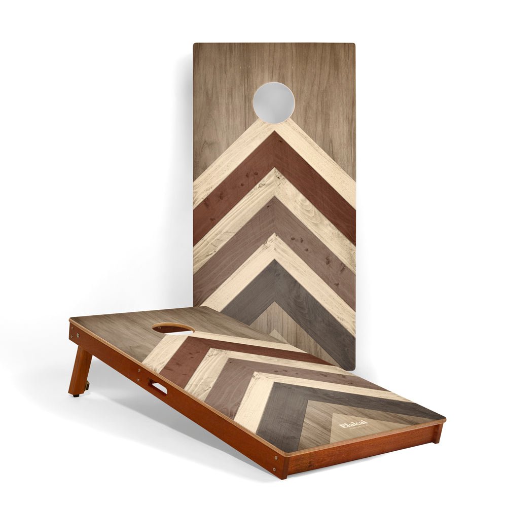Wooden cornhole board with chevron pattern on a white background