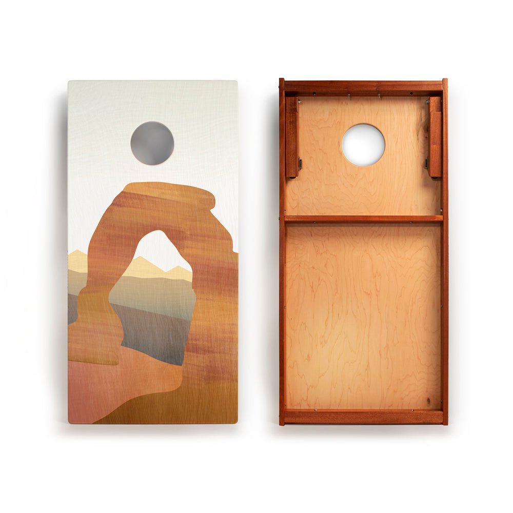 Wooden cornhole boards with landscape design on a white background