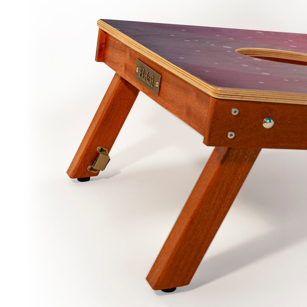 Wooden pet table with a purple top on a white background