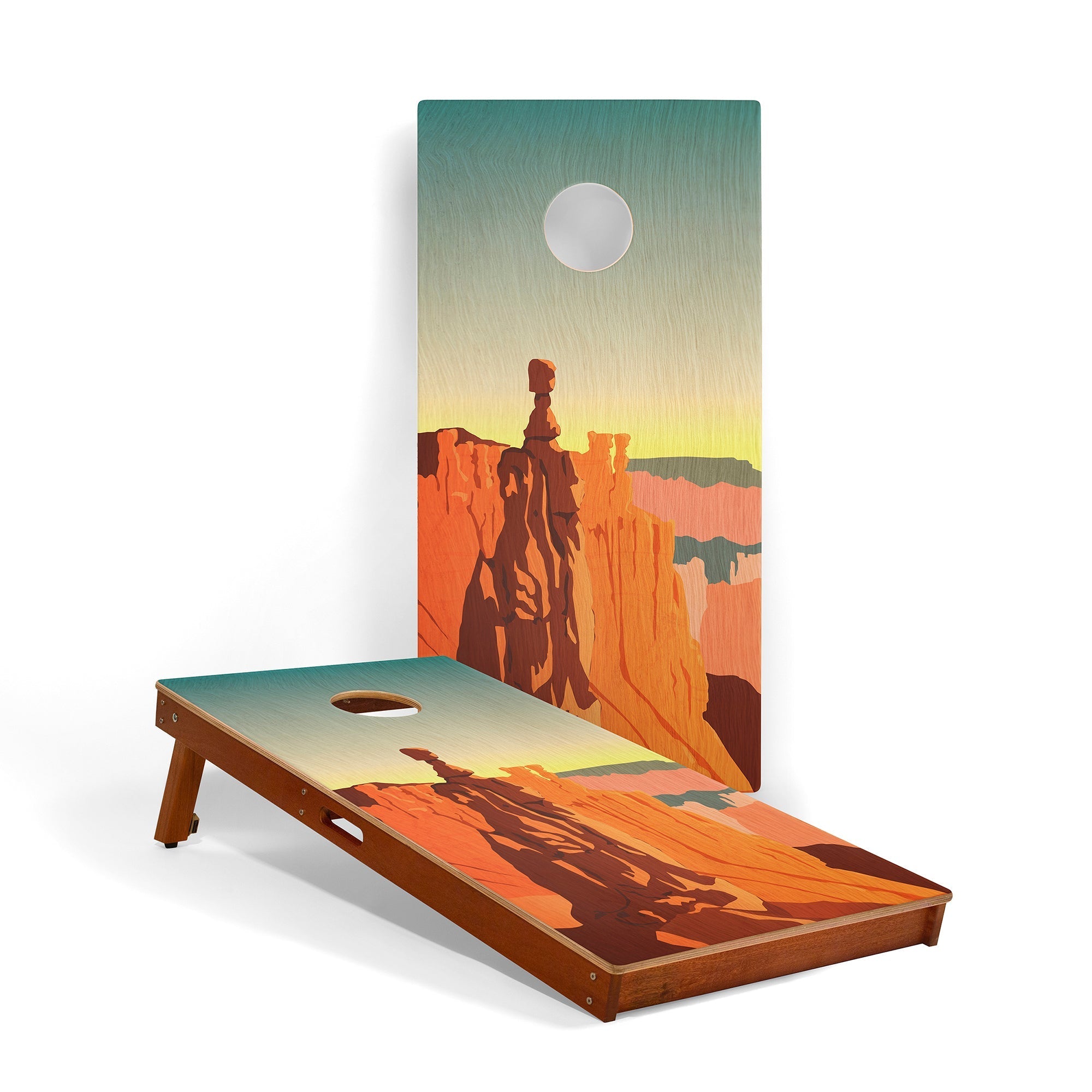 Cornhole board with desert landscape design featuring a silhouette of a person on horseback.
