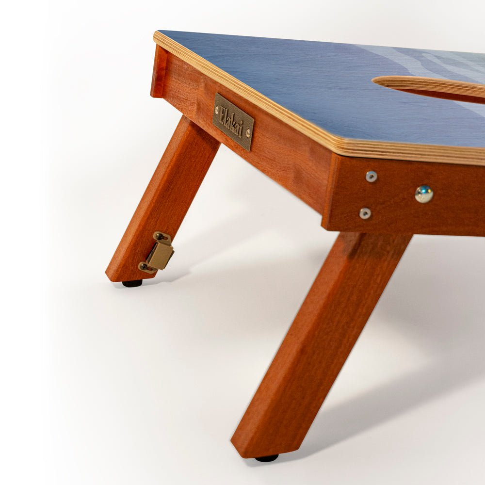 Wooden table with blue top on a white background