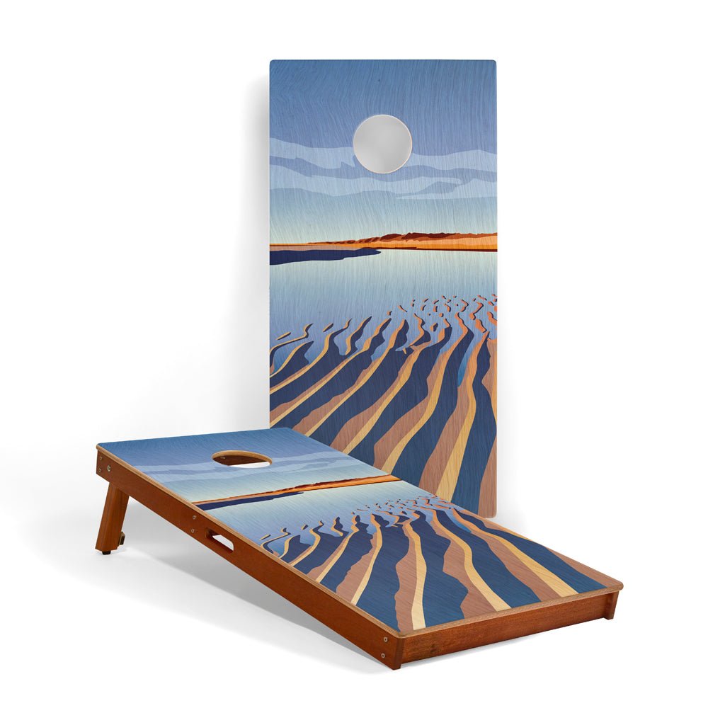 Cornhole board with beach scene design on a white background