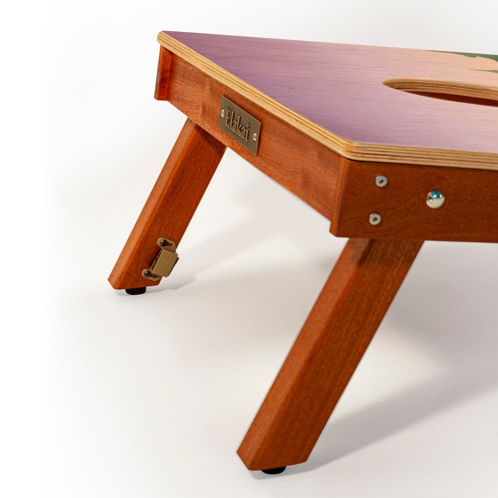 Wooden adjustable bed table with a visible brand label on a white background