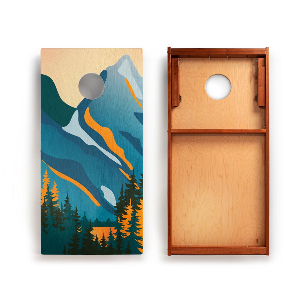 Cornhole board with mountain design on one side and plain wood on the other