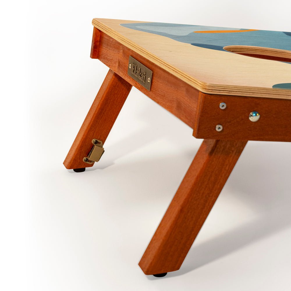 Wooden children's table with a visible brand label on a white background